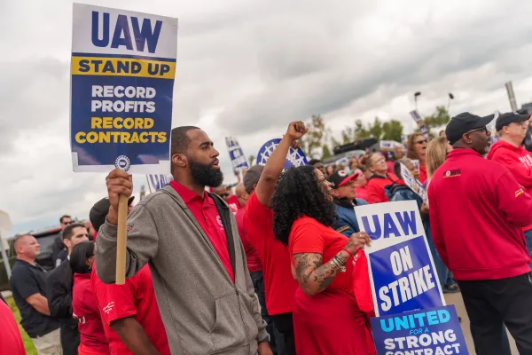 UAW picketers holding signs at a rally